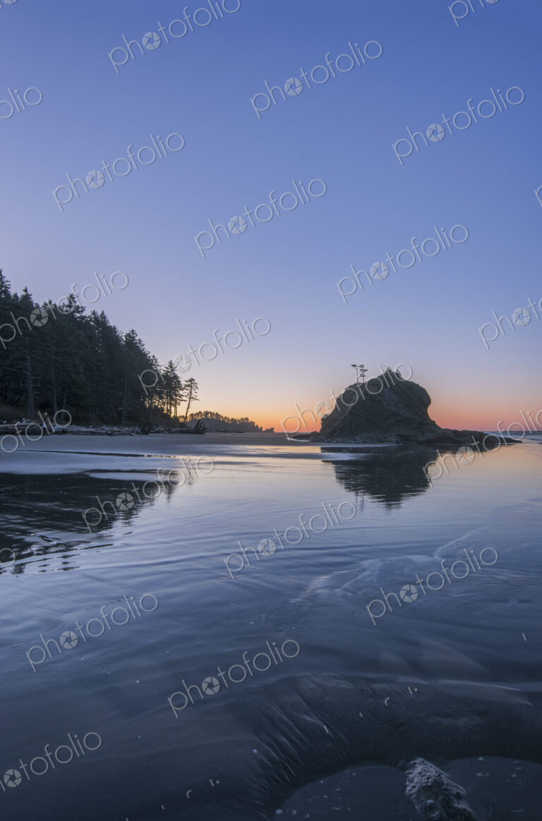 Second Beach at low tide, seastacks offshore silhouetted at sunset.