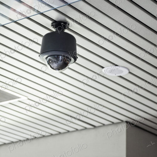 Security camera in a lobby area of a new building. Security camera in a lobby area of a new building.