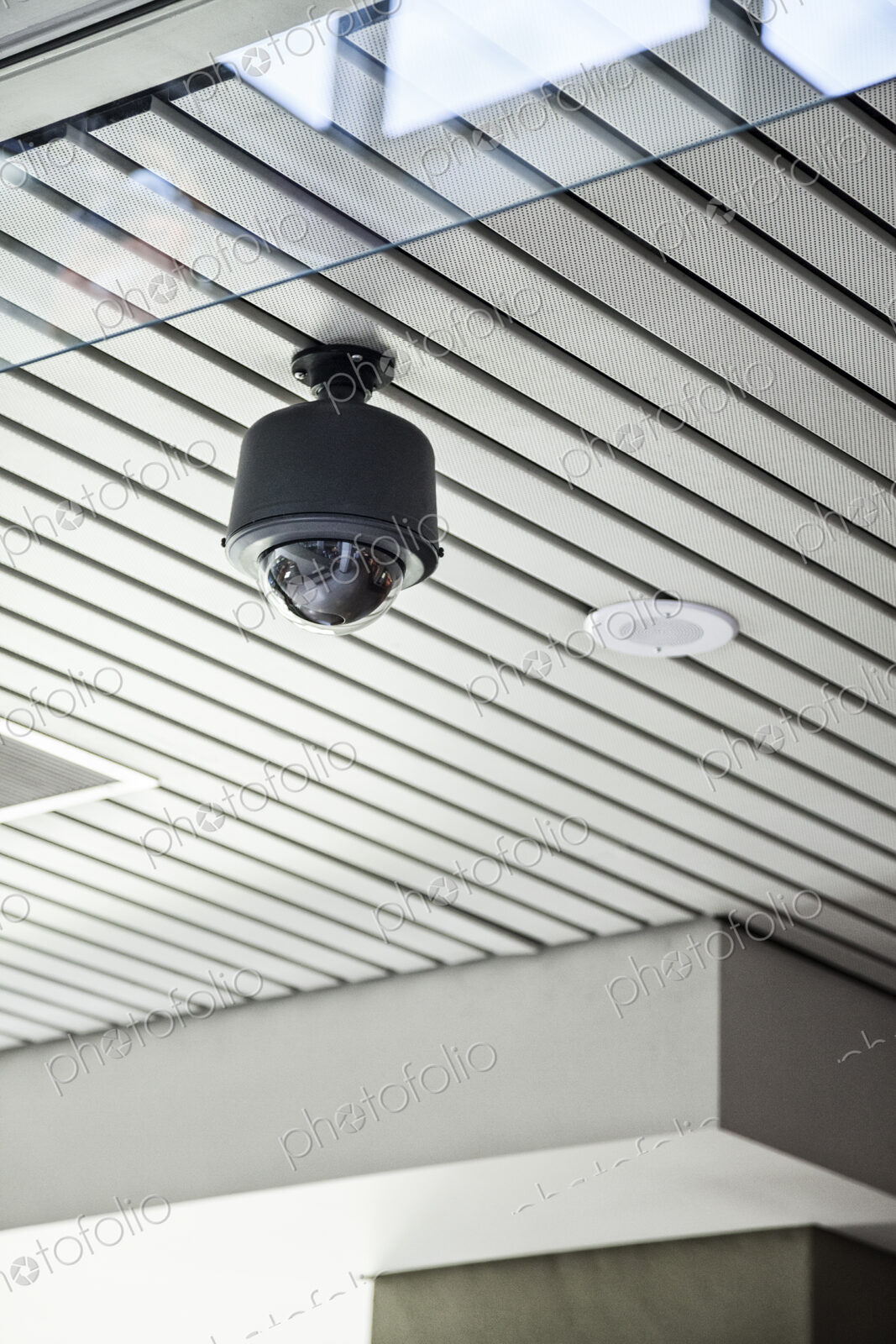 Security camera in a lobby area of a new building.