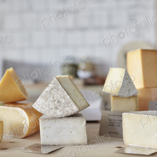 Selection of cheeses on counter in shop