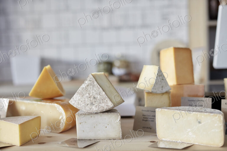 Selection of cheeses on counter in shop