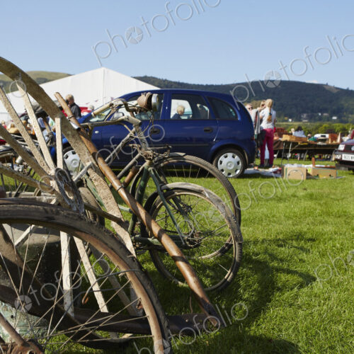 Selection of vintage bicycles, wheel rim and an old milk churn for sale at a flea… Selection of vintage bicycles, wheel rim and an old milk churn for sale at a flea…
