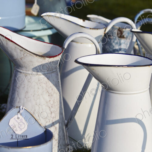 Selection of white vintage enamel jugs for sale.