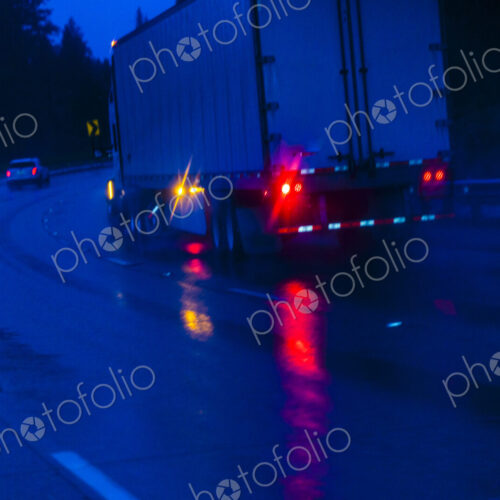 Semi-truck at Night driving in the rain on Interstate 90 through the Cascade Mountains Semi-truck at Night driving in the rain on Interstate 90 through the Cascade Mountains