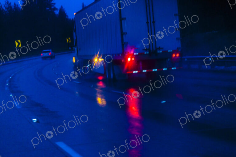 Semi-truck at Night driving in the rain on Interstate 90 through the Cascade Mountains