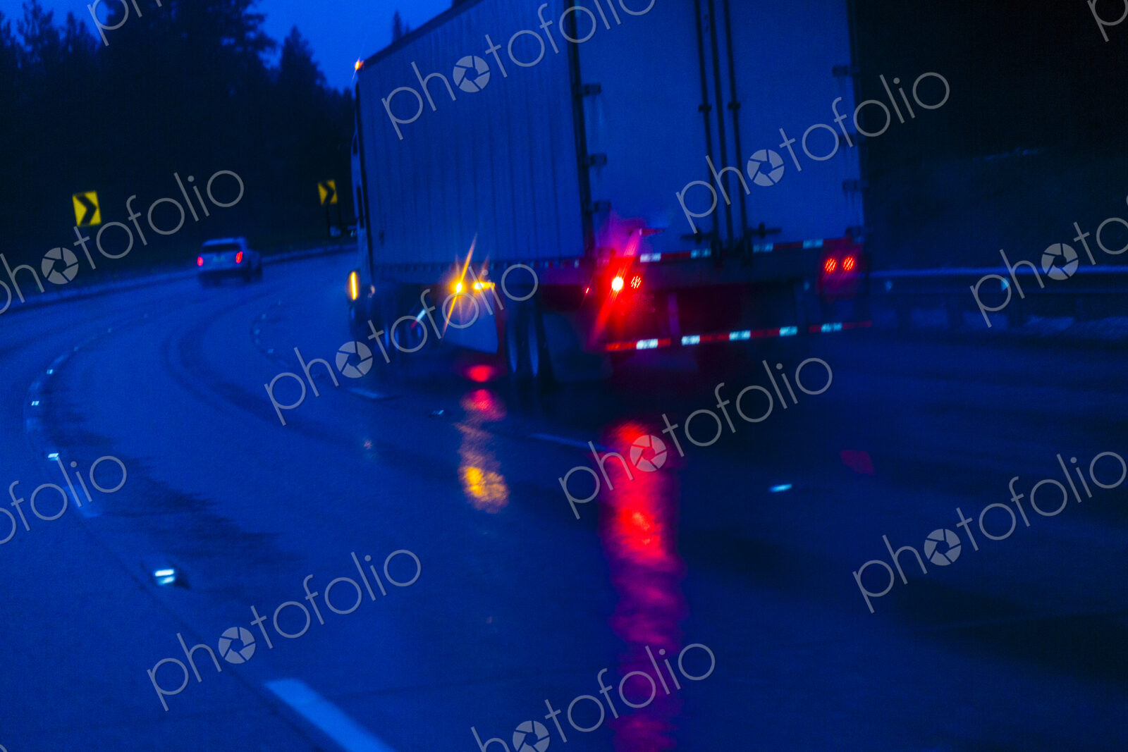 Semi-truck at Night driving in the rain on Interstate 90 through the Cascade Mountains