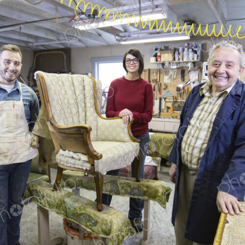 Senior Caucasian man upholsterer and his understudy team of young people working on an… Senior Caucasian man upholsterer and his understudy team of young people working on an…