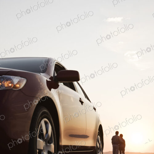 Senior couple watching a sunset from a rest stop on a road trip in eastern Washington…