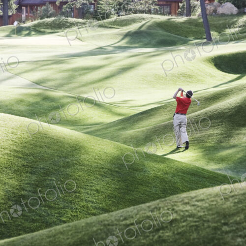 Senior golfer hitting a second shot from the fairway of a golf course. Senior golfer hitting a second shot from the fairway of a golf course.