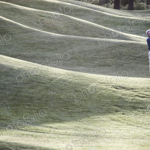 Senior golfer hitting a second shot from the fairway of a golf course. Senior golfer hitting a second shot from the fairway of a golf course.