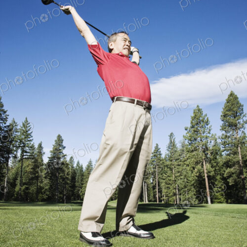 Senior golfer stretching with a golf club prior to playing a round of golf. Senior golfer stretching with a golf club prior to playing a round of golf.