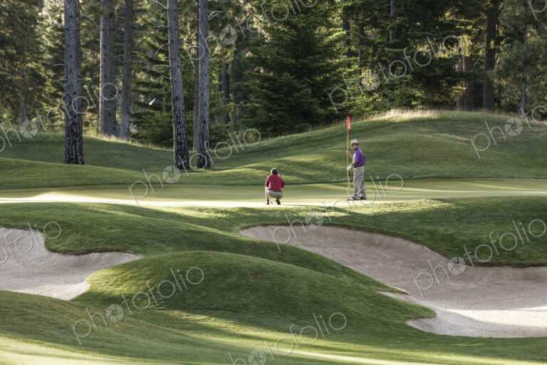 Senior golfers on one of the greens of the golf course.