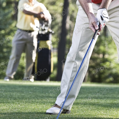 Senior golfers teeing off on a golf course hole. Senior golfers teeing off on a golf course hole.