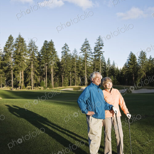 Senior golfing couple on the golf course.