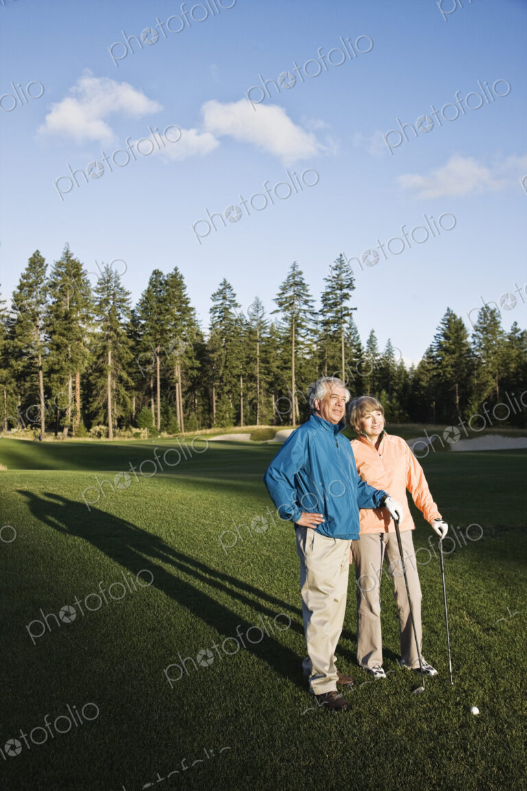 Senior golfing couple on the golf course.