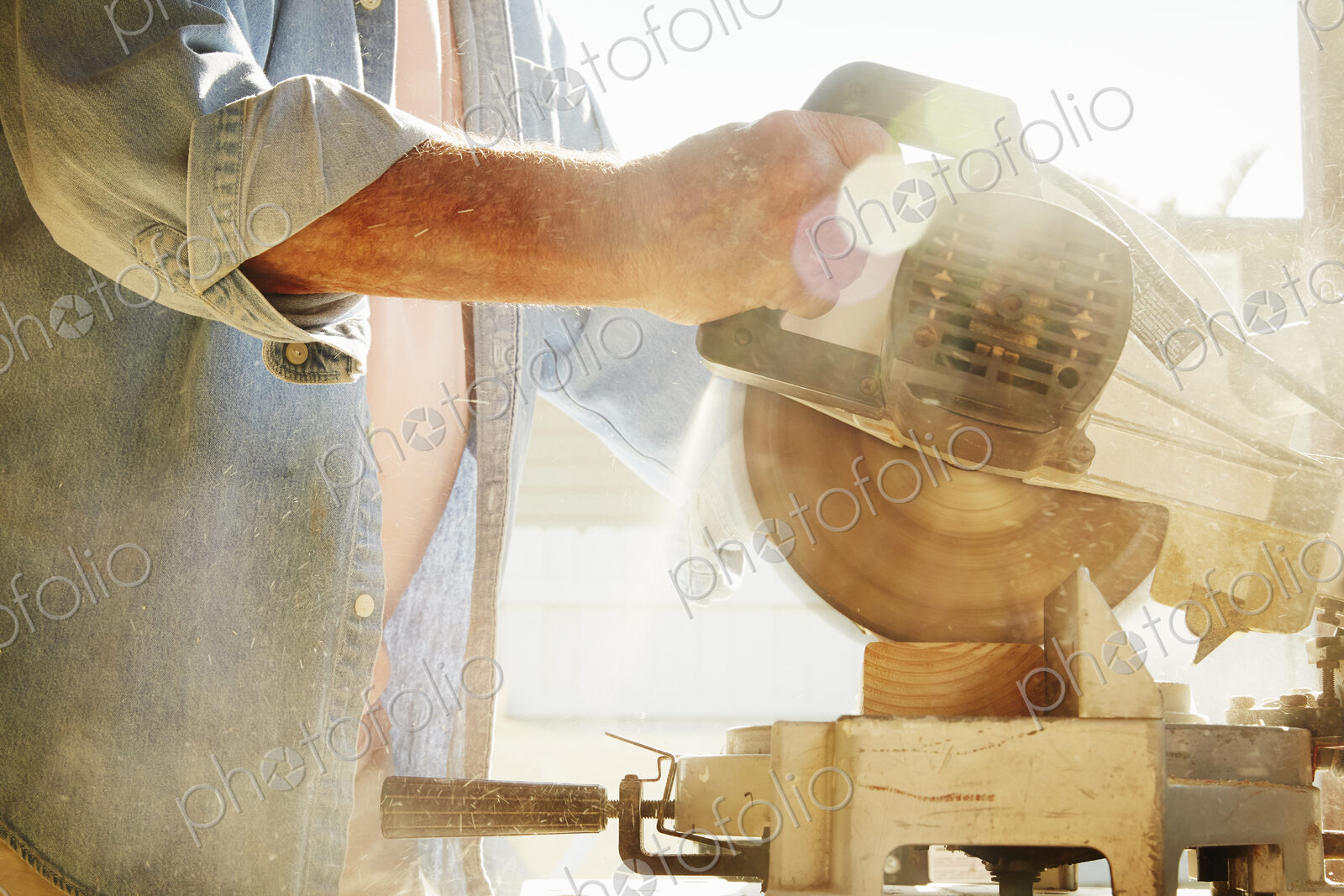 Senior man using a circular saw.