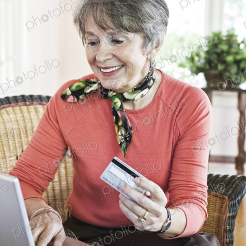 Senior woman buying a product online with a credit card. Senior woman buying a product online with a credit card.