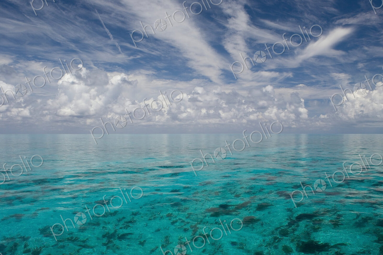 Serene view of calm shallow clear ocean water. Limitless horizon.