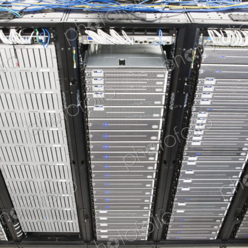 Server room aisle showing computer servers and CAT 5 cables. Server room aisle showing computer servers and CAT 5 cables.
