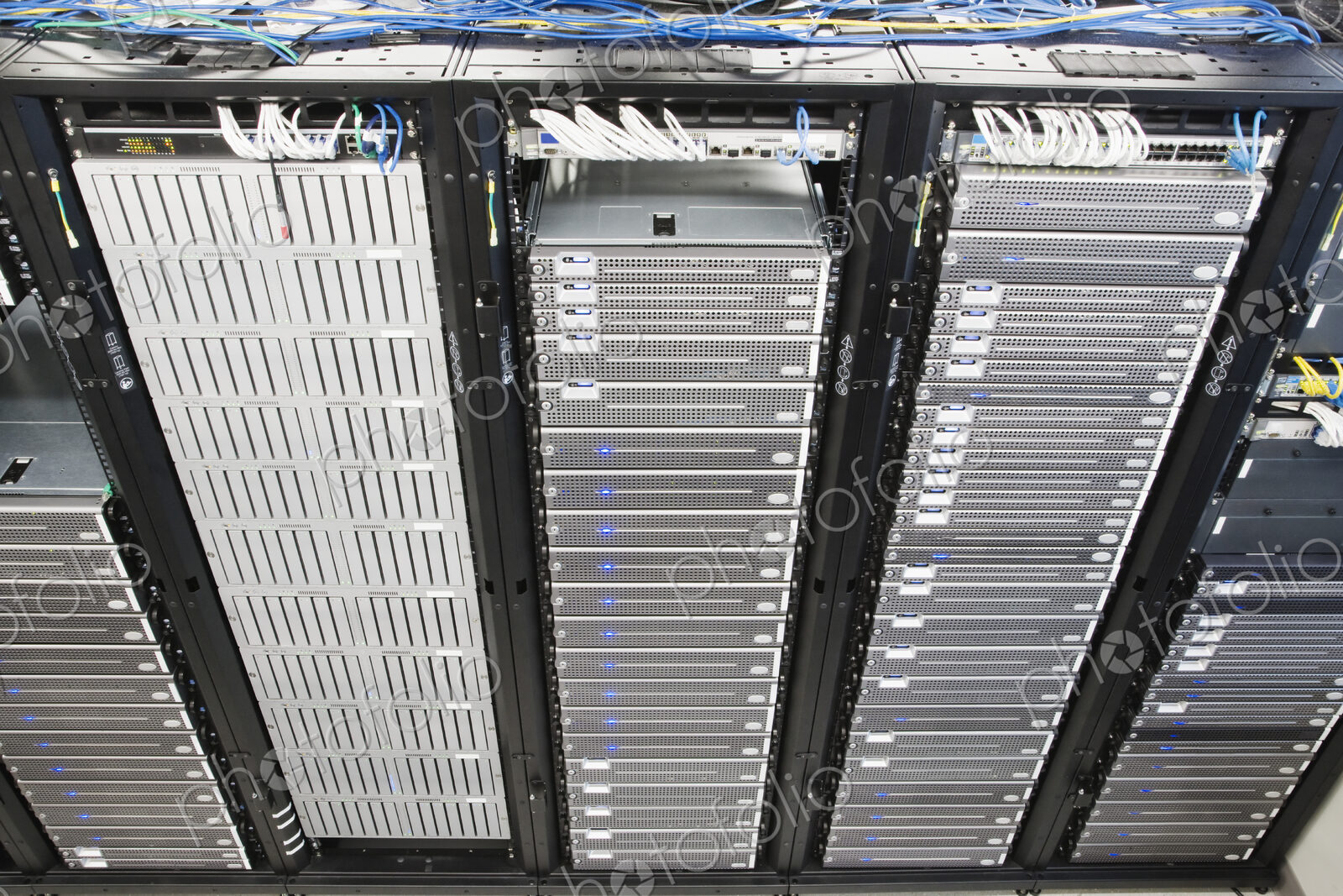 Server room aisle showing computer servers and CAT 5 cables.