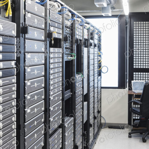 Servers in an aisle of racks in a computer server farm. Servers in an aisle of racks in a computer server farm.