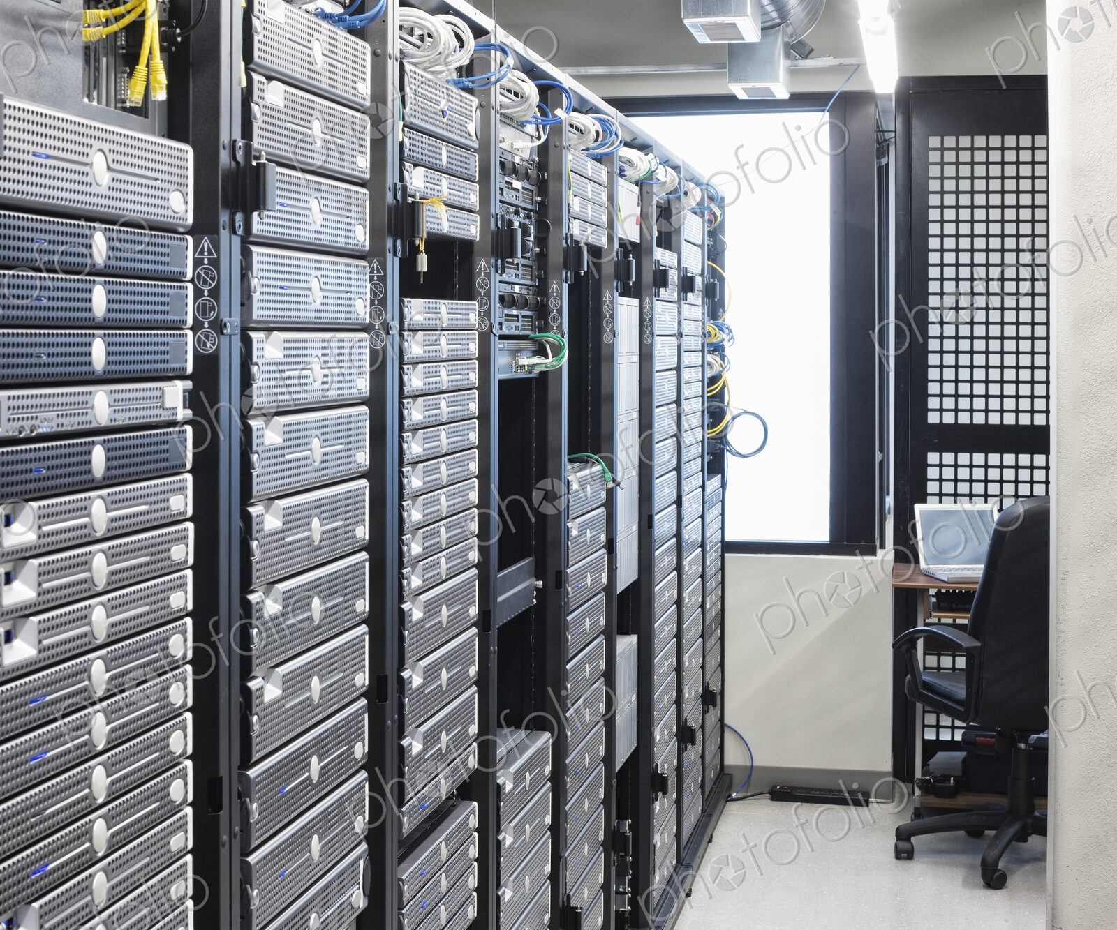 Servers in an aisle of racks in a computer server farm.