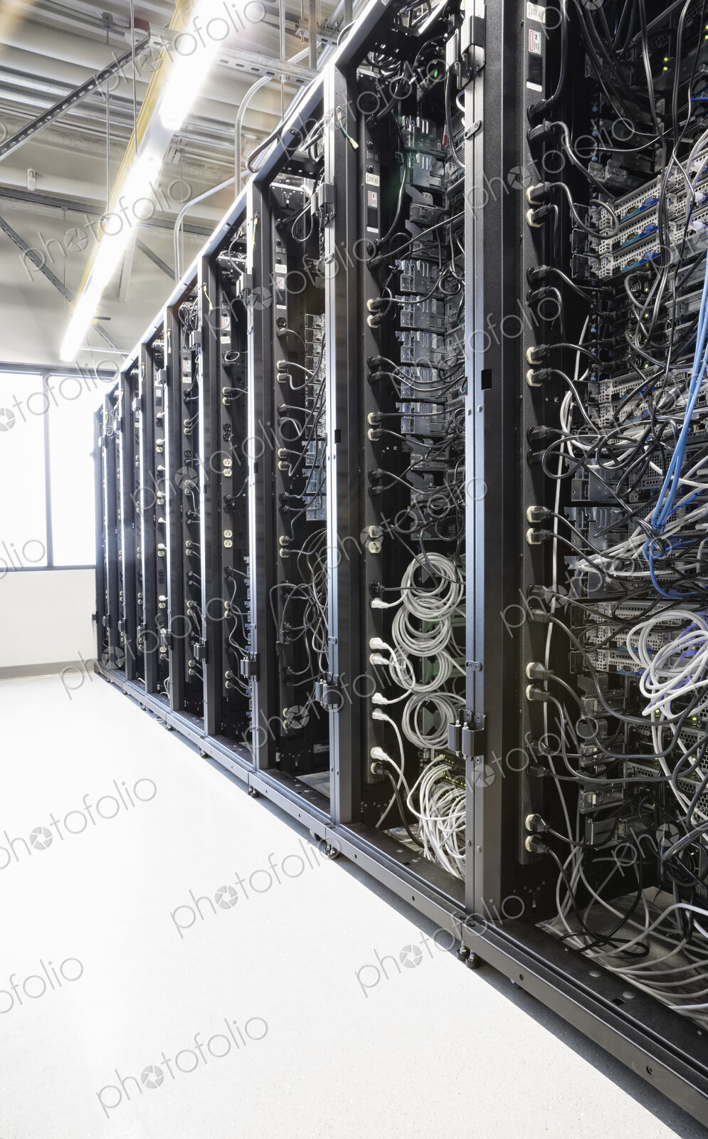 Servers in an aisle of racks in a computer server farm.