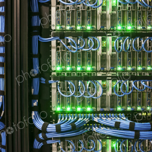 Servers with CAT 5 cables on racks in a large computer server farm. Servers with CAT 5 cables on racks in a large computer server farm.