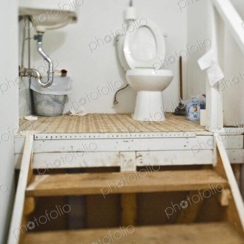 Set of steps and a toilet and basin. Set of steps and a toilet and basin.