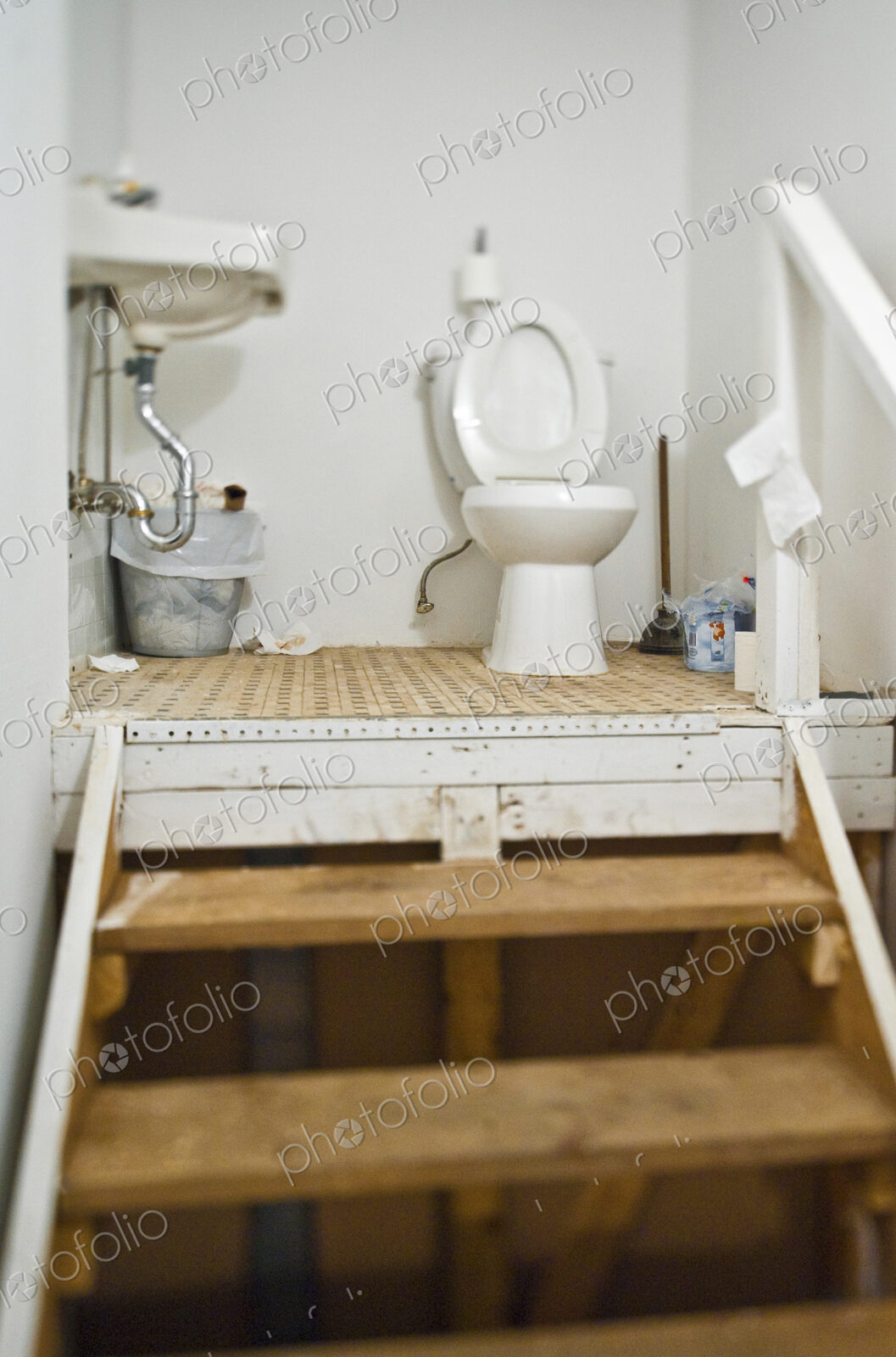 Set of steps and a toilet and basin.