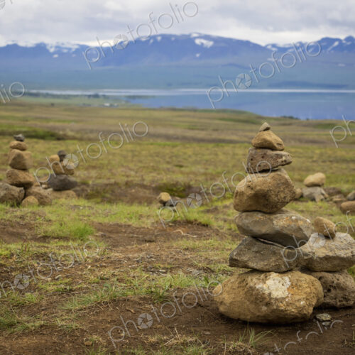 Several small stone cairns, made by balancing rocks in a pile. Several small stone cairns, made by balancing rocks in a pile.