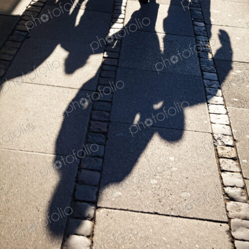 Shadows of family on sidewalk, Denmark
