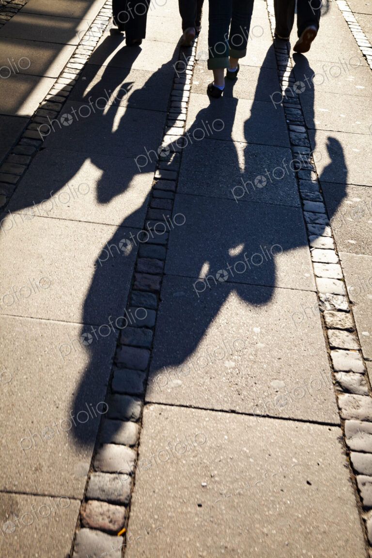 Shadows of family on sidewalk, Denmark