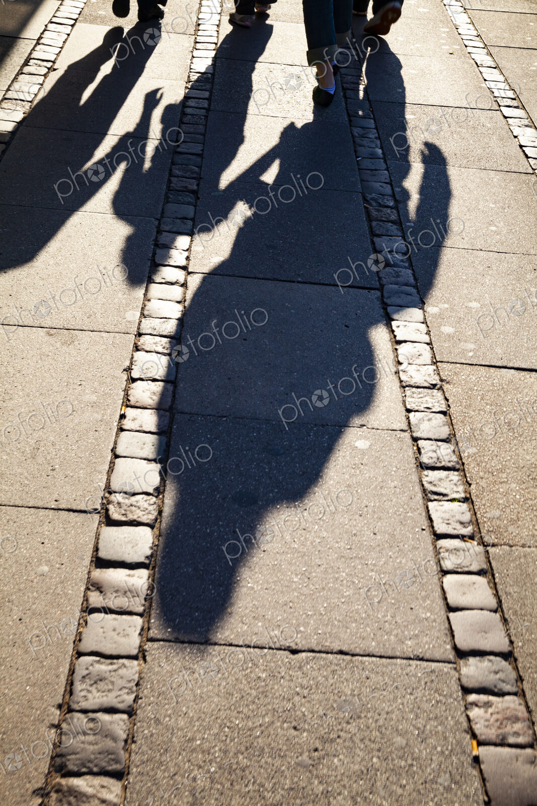 Shadows of family on sidewalk, Denmark