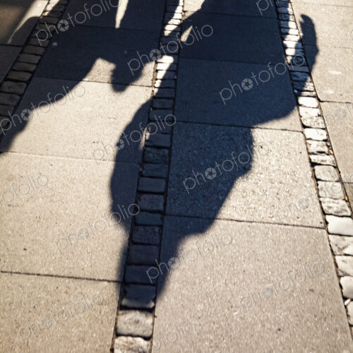 Shadows of family on sidewalk, Denmark Shadows of family on sidewalk, Denmark