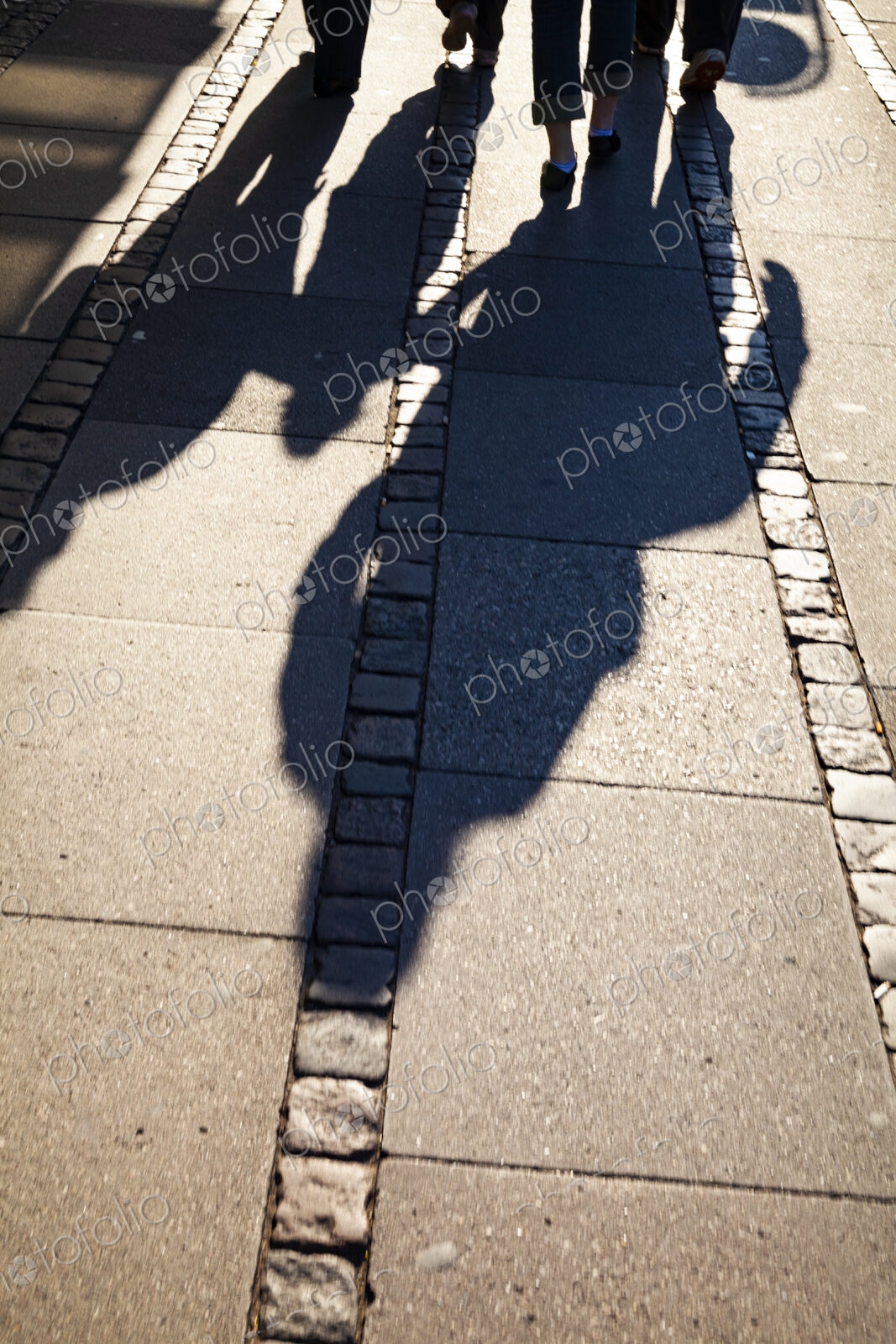Shadows of family on sidewalk, Denmark