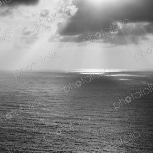 Shafts of sunlight shining through cloud and a view over the Pacific Ocean, at… Shafts of sunlight shining through cloud and a view over the Pacific Ocean, at…