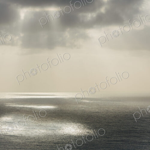 Shafts of sunlight shining through cloud and a view over the Pacific Ocean, at… Shafts of sunlight shining through cloud and a view over the Pacific Ocean, at…