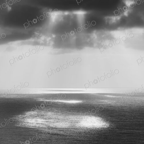 Shafts of sunlight shining through cloud and a view over the Pacific Ocean, at… Shafts of sunlight shining through cloud and a view over the Pacific Ocean, at…