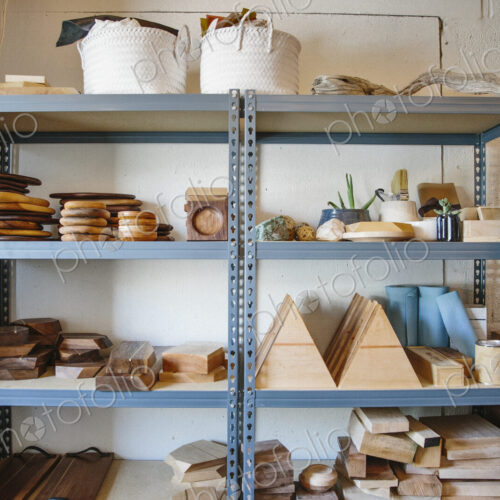 Shelves in a wood turner's workshop, a display of smooth round platters and bowls.