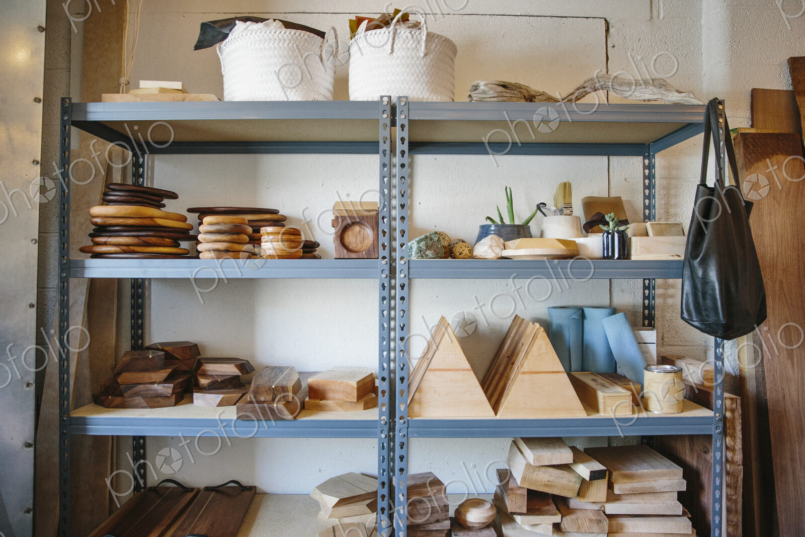 Shelves in a wood turner’s workshop, a display of smooth round platters and bowls.