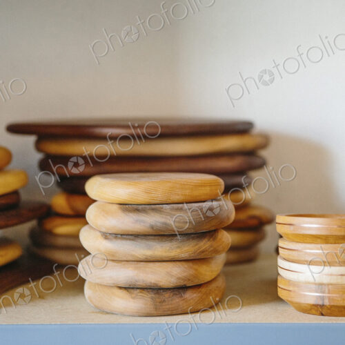 Shelves in a wood turner's workshop and a display of smooth wooden bowls.