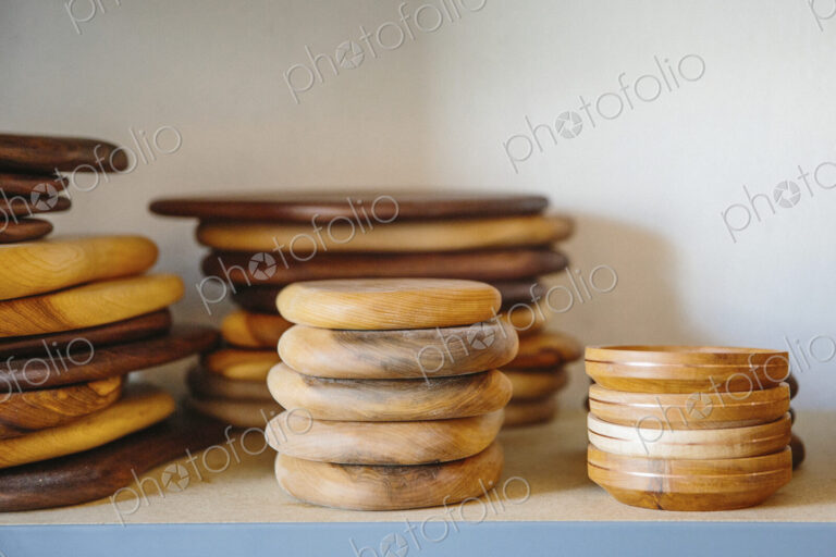 Shelves in a wood turner's workshop and a display of smooth wooden bowls.