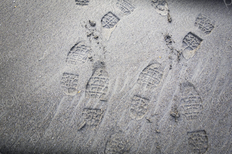 Shoe prints on beach sand, WA USA