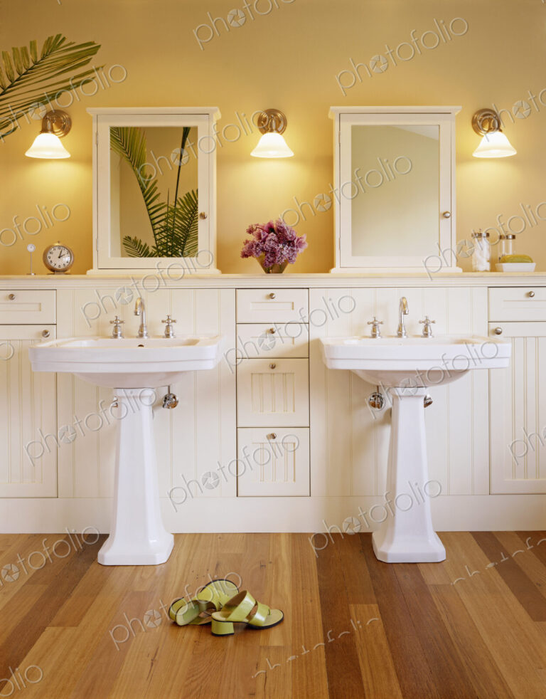 Shoes and pedestal sinks in luxury bathroom