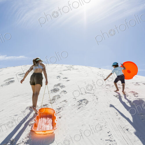 Siblings climbing sand dune Siblings climbing sand dune