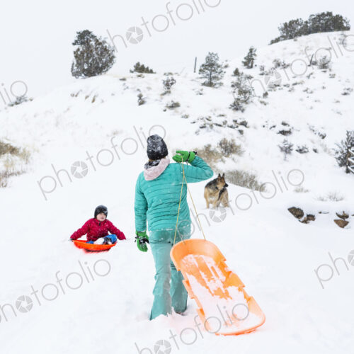 Siblings sledding down hill Siblings sledding down hill