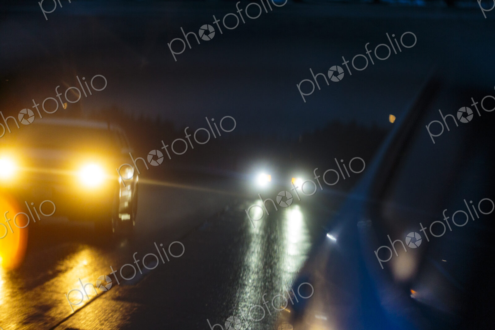 Side mirror reflection, a journey in stormy wet weather in the dark on Interstate 90.