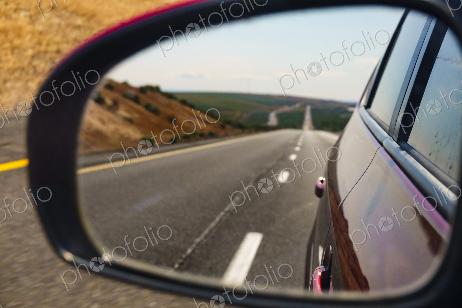 Side mirror reflection of remote highway, Interstate 90, WA USA