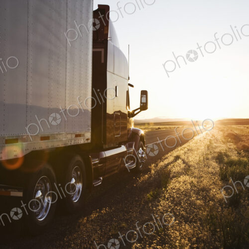 Side view of a trailer and truck on the road at sunset in eastern Washington, USA Side view of a trailer and truck on the road at sunset in eastern Washington, USA